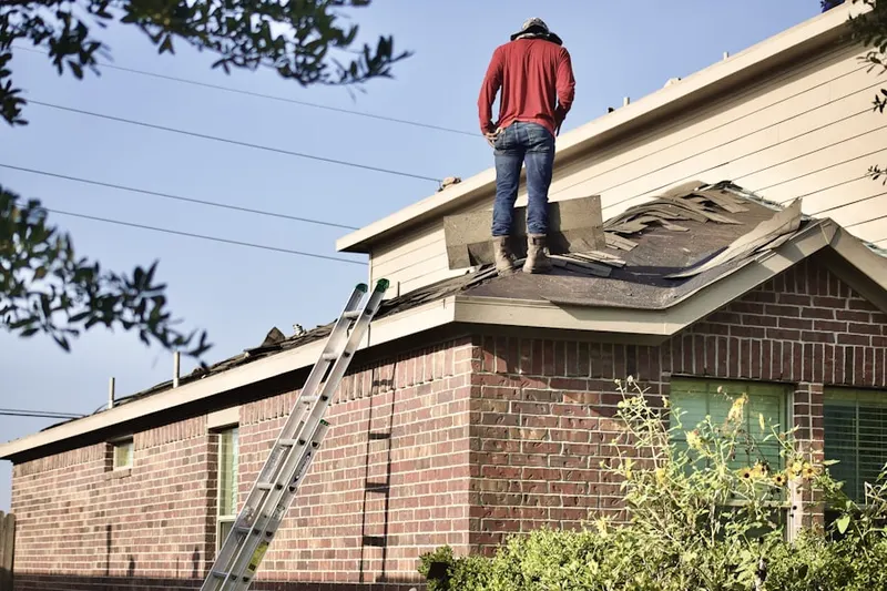 Professional roofer working on a residential roof in Loveland Park